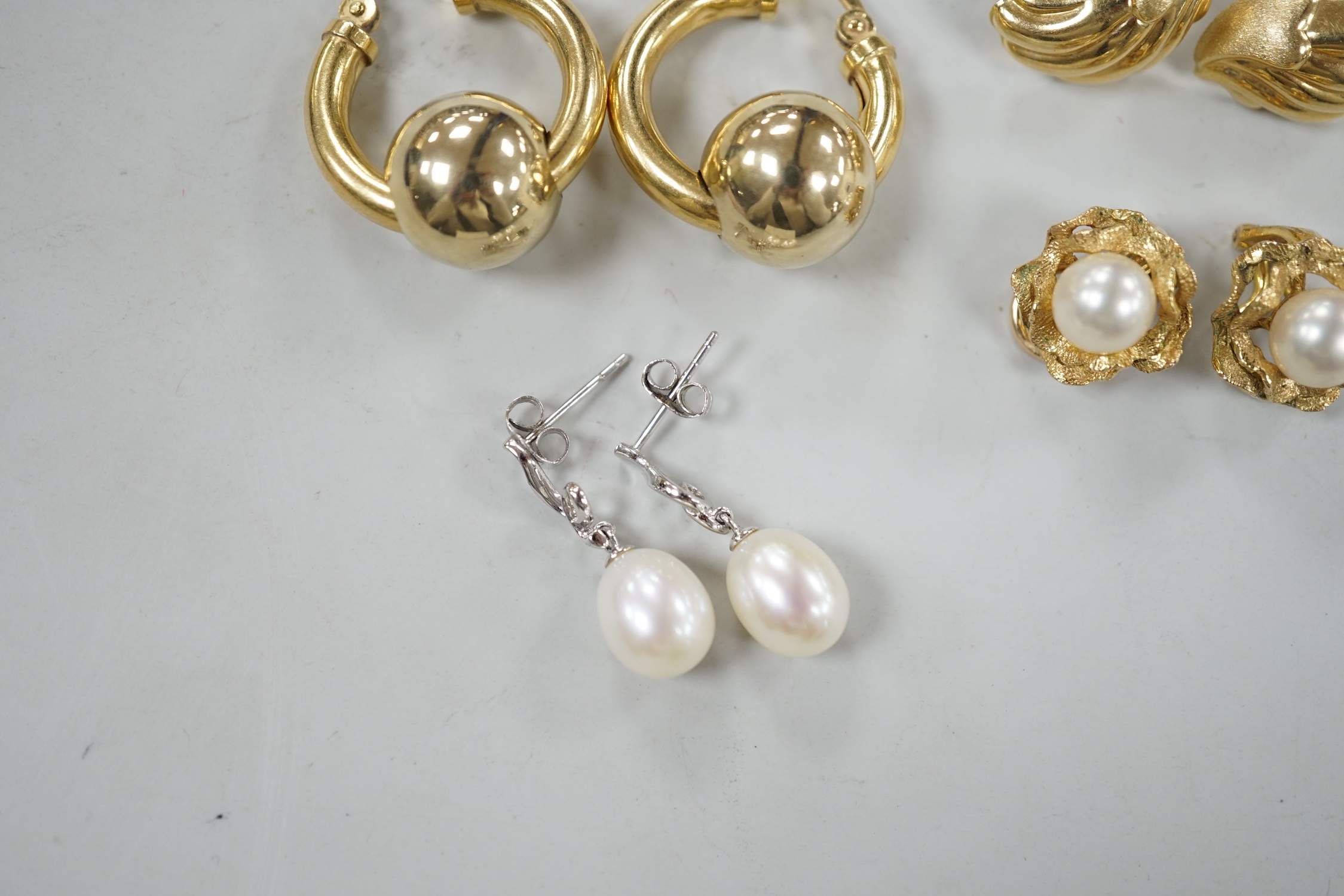 Two pairs of 750 yellow metal earrings, 12.6 grams and two pairs of 375 and cultured pearl set earrings, gross weight 7.2 grams.